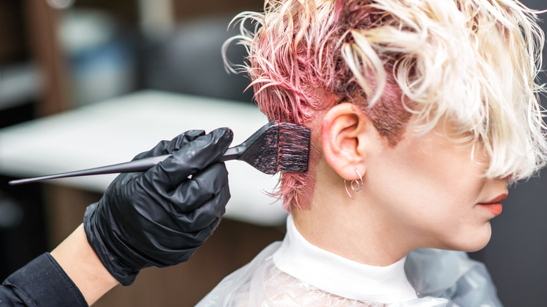 Woman dyeing hair pink