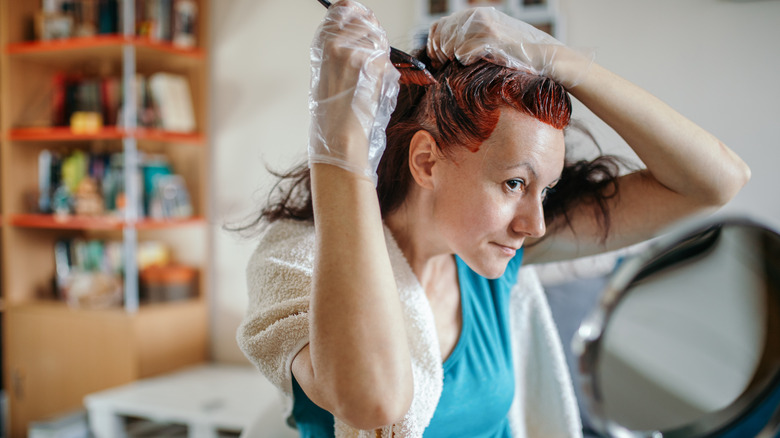 Woman dyeing hair at home