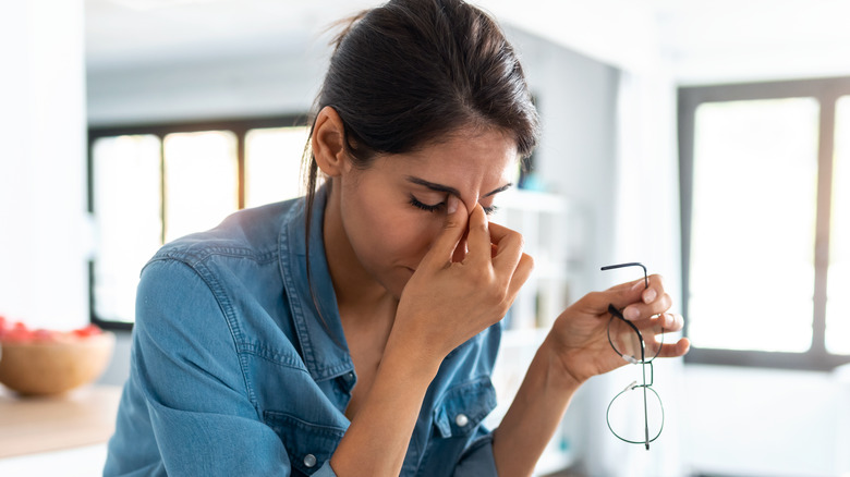 woman stressed holding brow