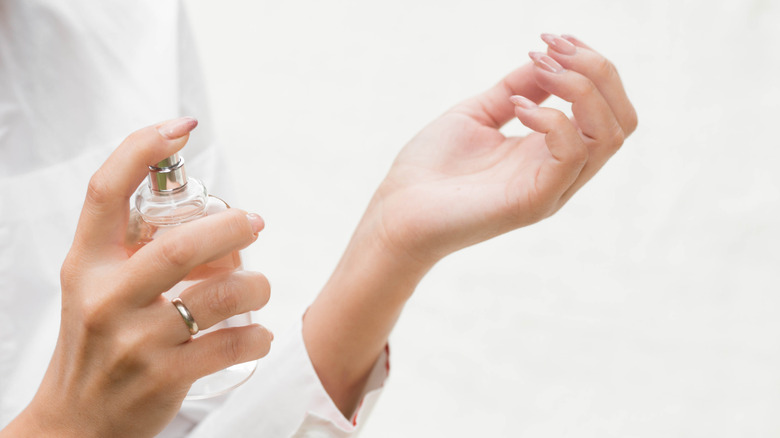 woman applying perfume