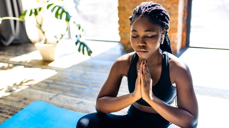 woman meditating at home