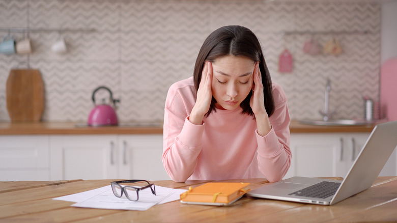 stressed out woman at table