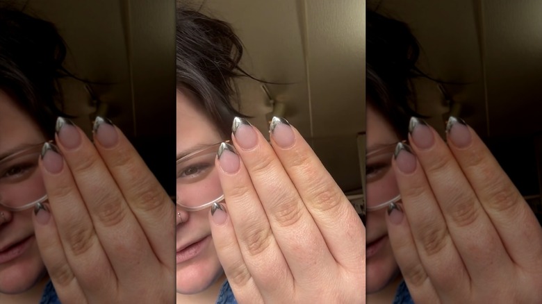 Person showing off their chrome French arrow nails on TikTok