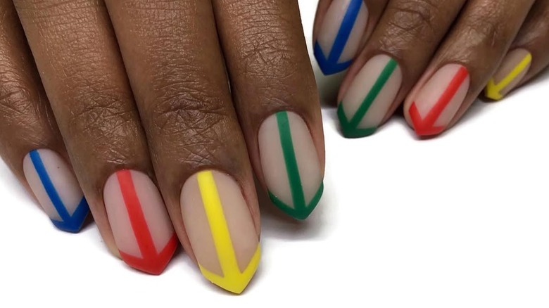 Person's fingers with an arrow shaped nail and colorful arrow-inspired design