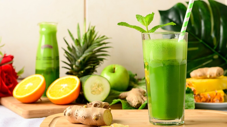 Juice with surrounding fruits and vegetables