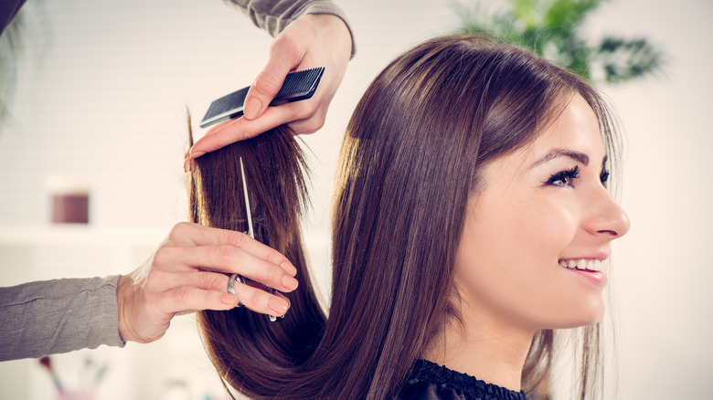 A woman getting her hair cut