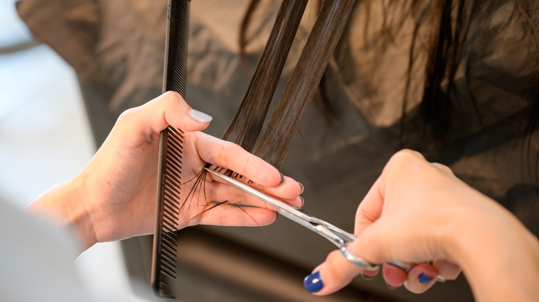 A woman trimming hair