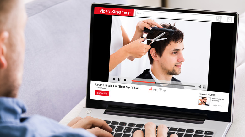 A man watching a hair cutting tutorial