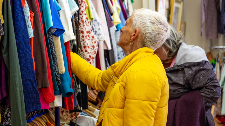 Women shopping for blouses in thrift store