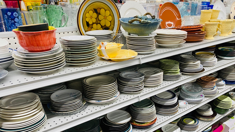 Dishware and kitchen items on thrift store shelves