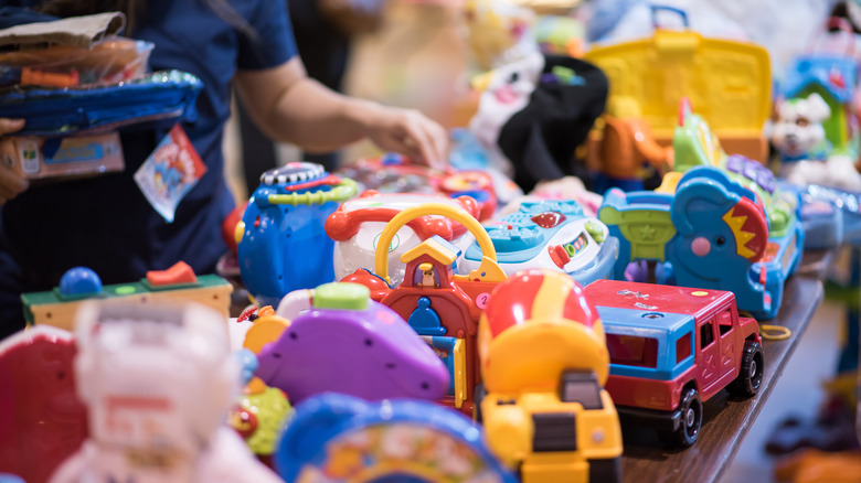 Secondhand children's toys arranged on a table for sale