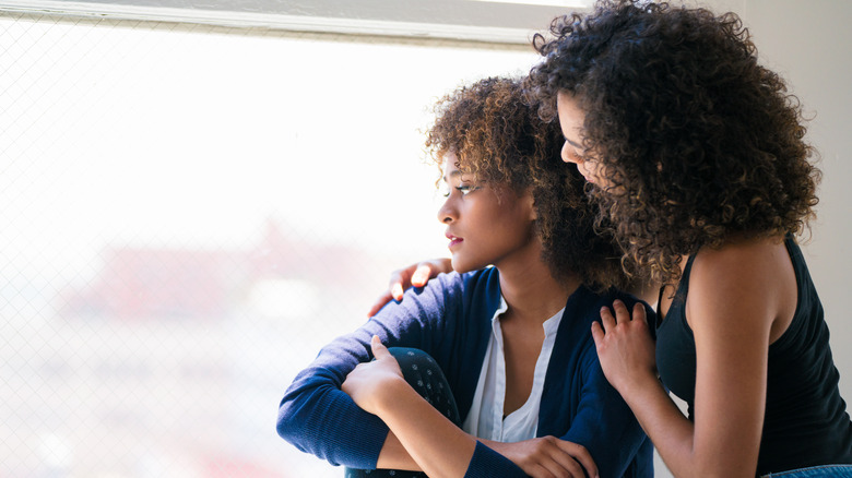 woman consoling her friend