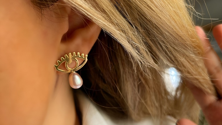 Woman wearing evil eye earring 