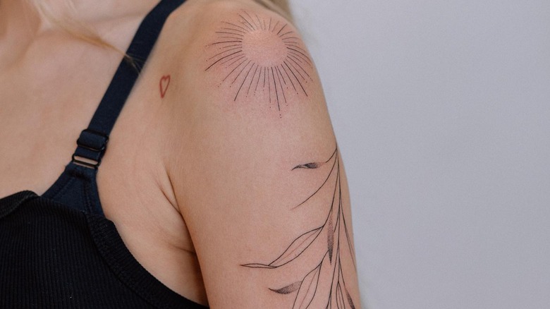 Fine line upper arm tattoo