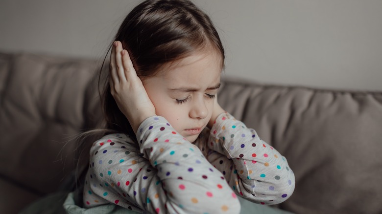 Child covering ears