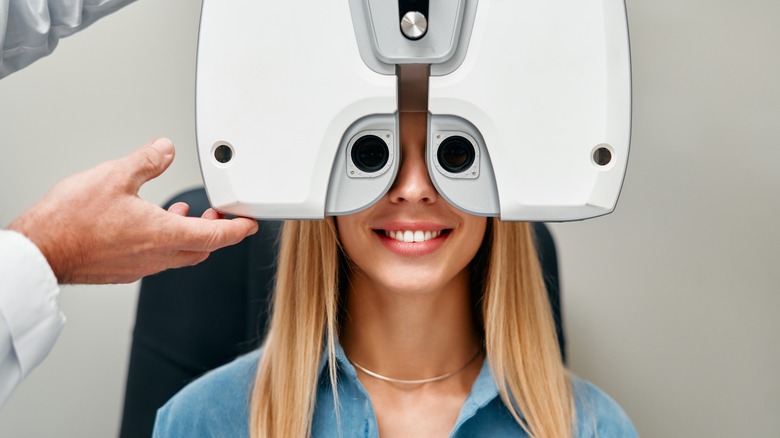 Woman being tested by optometrist