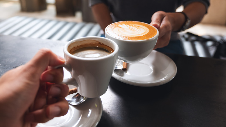 people holding coffee cups