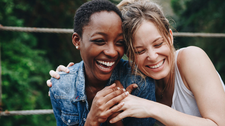 pair of young friends laughing together