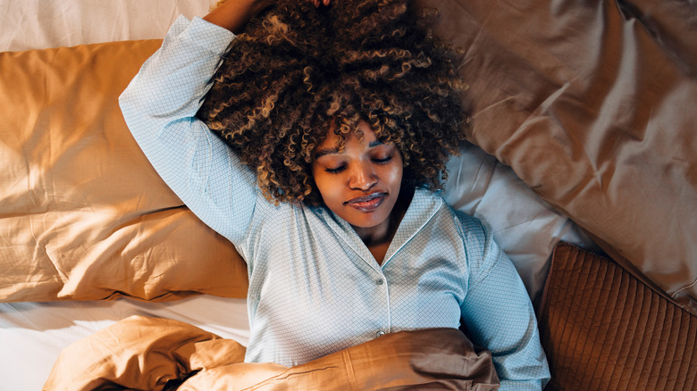 Sleeping woman with curly hair