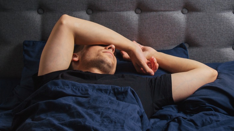 Man sleeping in starfish position