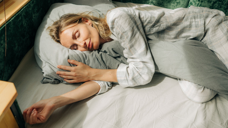 Woman sleeping in yearning position