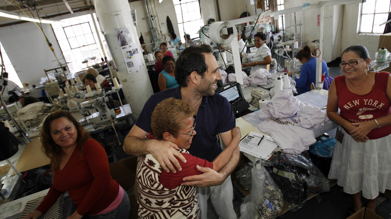 Dov Charney hugging a worker