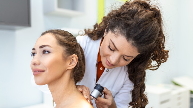 dermatologist examining patient