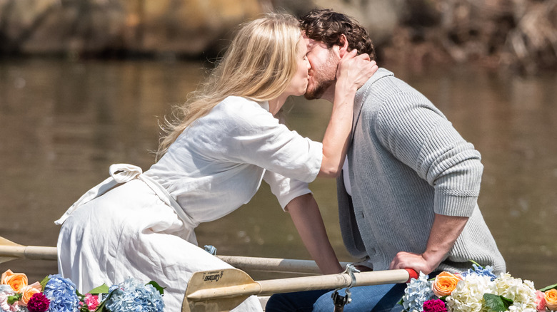 couple kissing in row boat