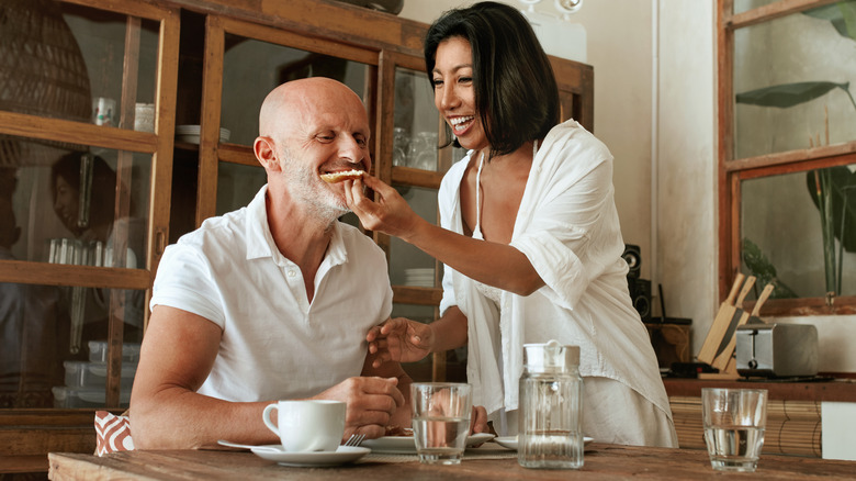 woman feeding male partner