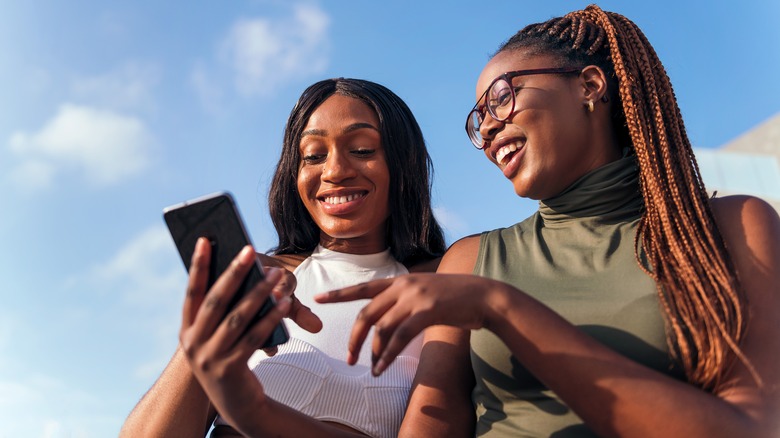 two friends looking at phone