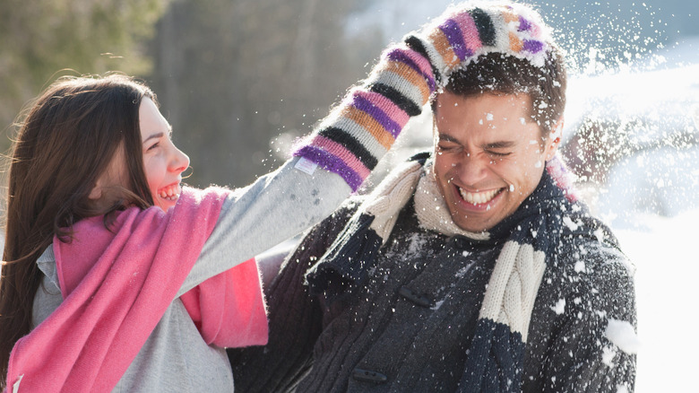 couple playing in the snow