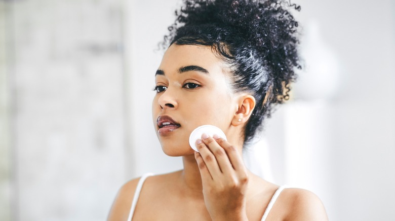 Woman cleansing her face