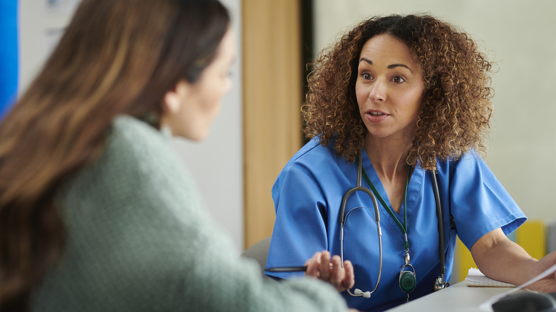 Woman speaking to doctor