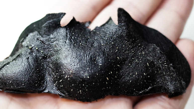 woman with used pore strip in hand 