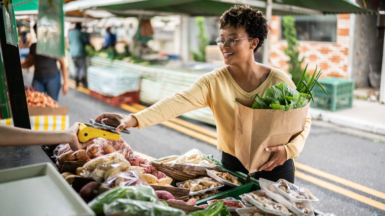 woman buying vegetables at market