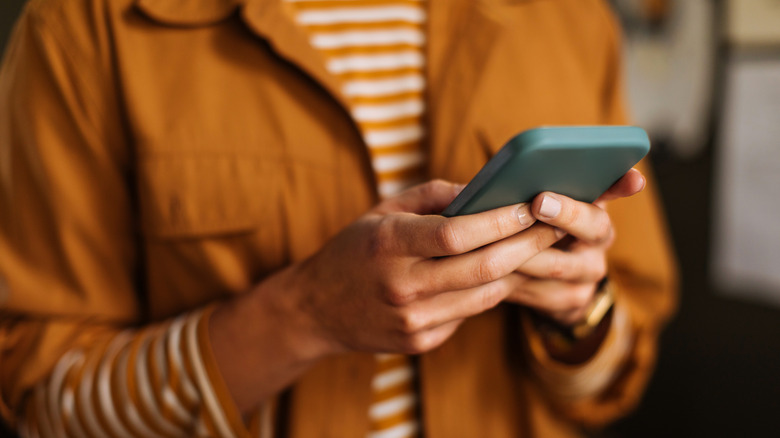 Woman holds phone