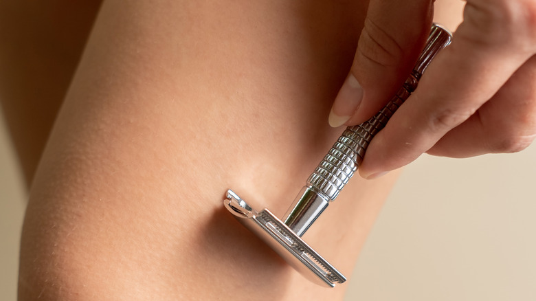 Woman using safety razor