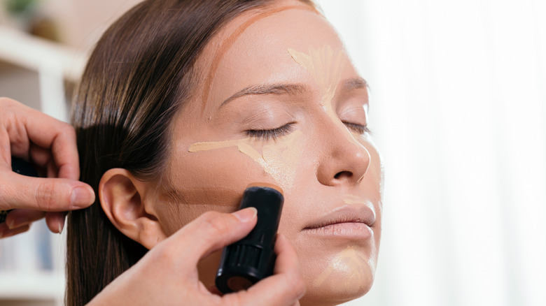 makeup artist applying contour
