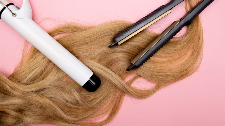 curling iron and straightener laying on top of fine hair
