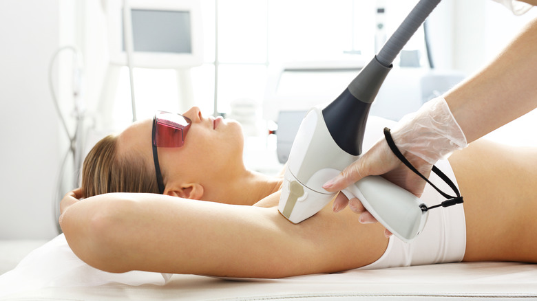 Patient getting laser hair removal on underarms