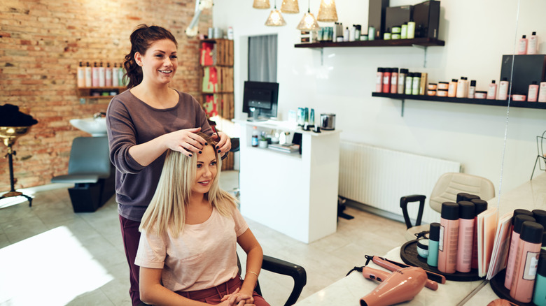 blond-haired woman having hair dyed