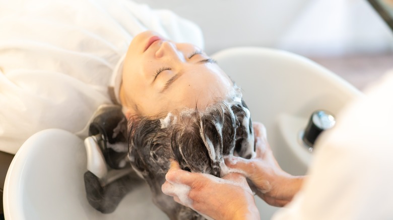 woman having hair washed