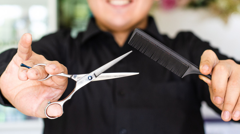 Stylist holding scissors and comb