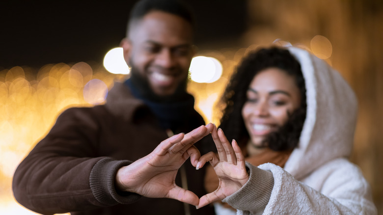 Man and woman making heart