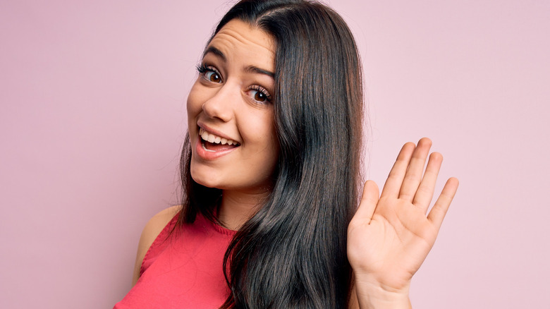 woman waving goodbye