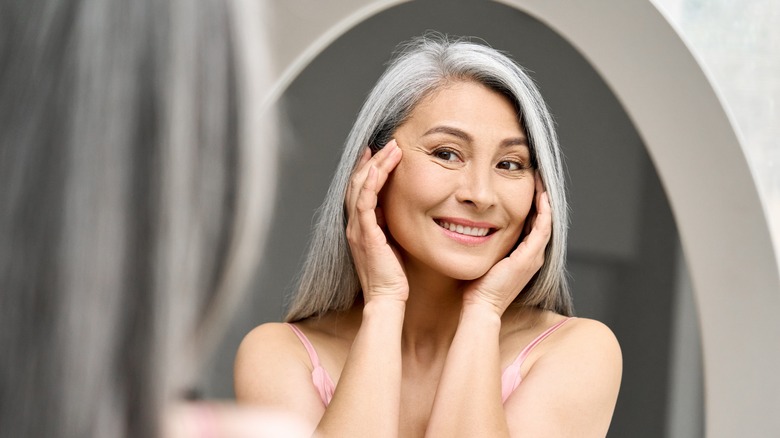 Woman admiring herself in the mirror