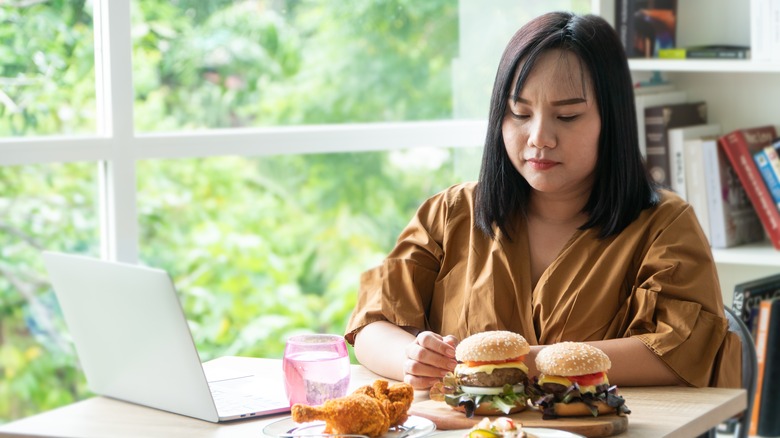 Woman with multiple food plates