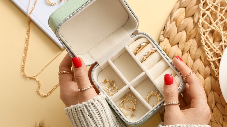 woman holding storage box of jewelry