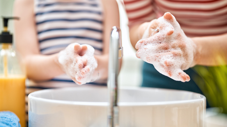 Two people washing hands 