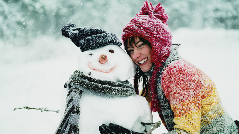 Woman posed with snowman